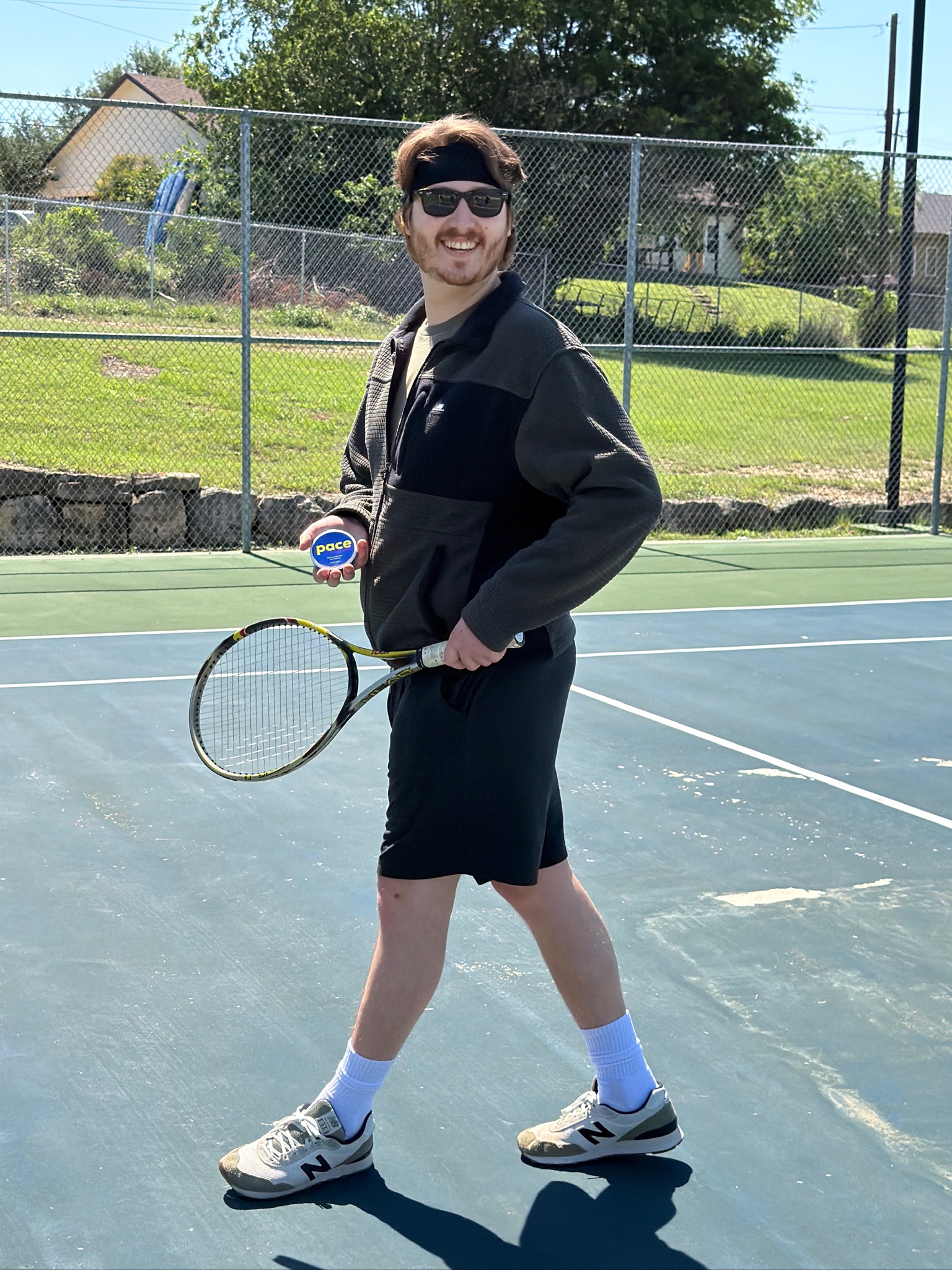 Pace founder on a tennis court holding a can